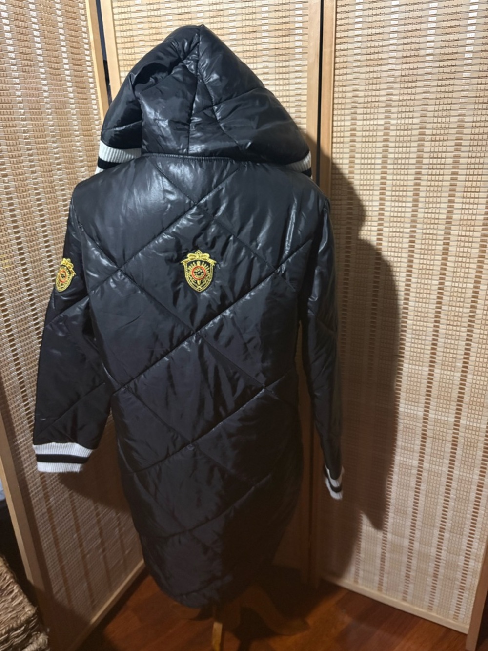 The jacket shown in the image is a vintage longline quilted puffer coat